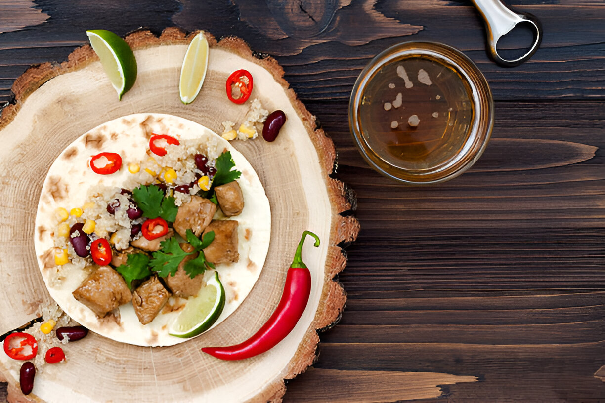 A delicious taco with tender meat, beans, corn, and fresh cilantro on a rustic wooden plate.