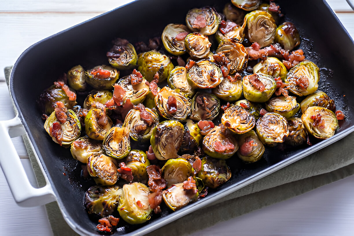 Roasted Brussels sprouts with crispy bacon in a black baking dish.