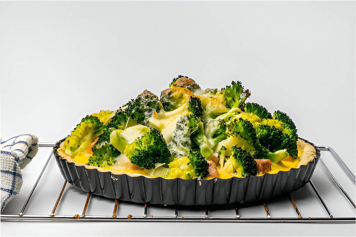 A delicious broccoli and cheese tart on a cooling rack, freshly baked.