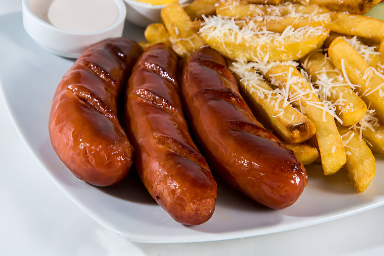 A plate featuring three grilled sausages and a side of golden French fries topped with shredded cheese.