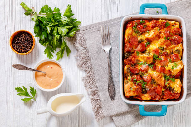 A delicious baked dish with sausage and herbs, served with sauces and fresh parsley.