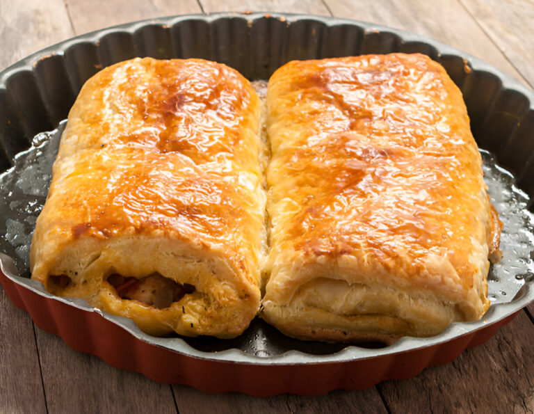 Golden-brown pastry rolls on a baking tray