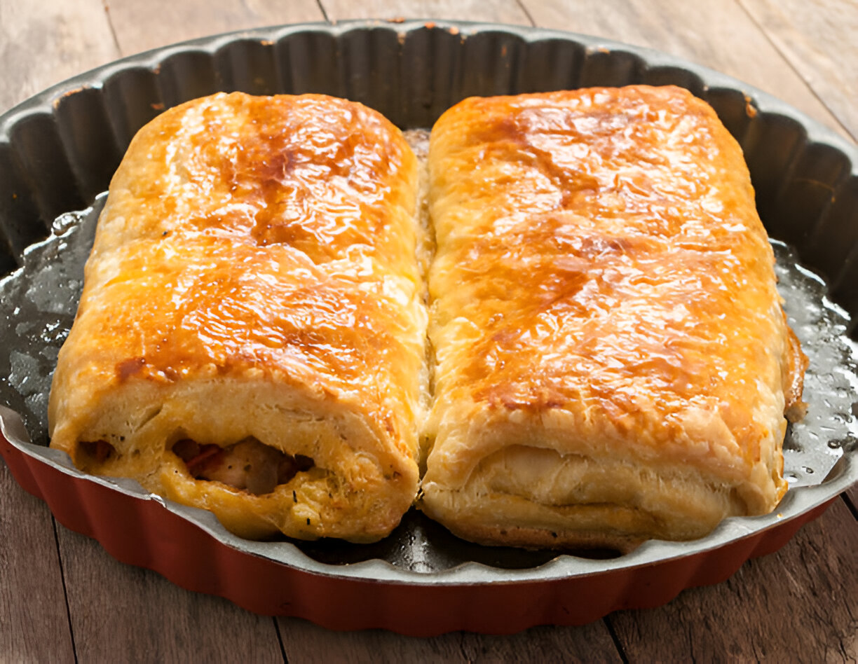 Golden-brown pastry rolls on a baking tray