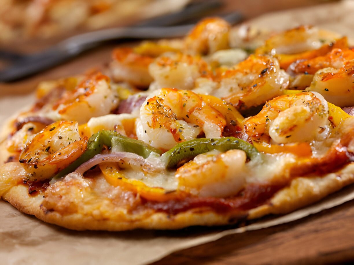 Delicious shrimp pizza topped with colorful bell peppers and herbs